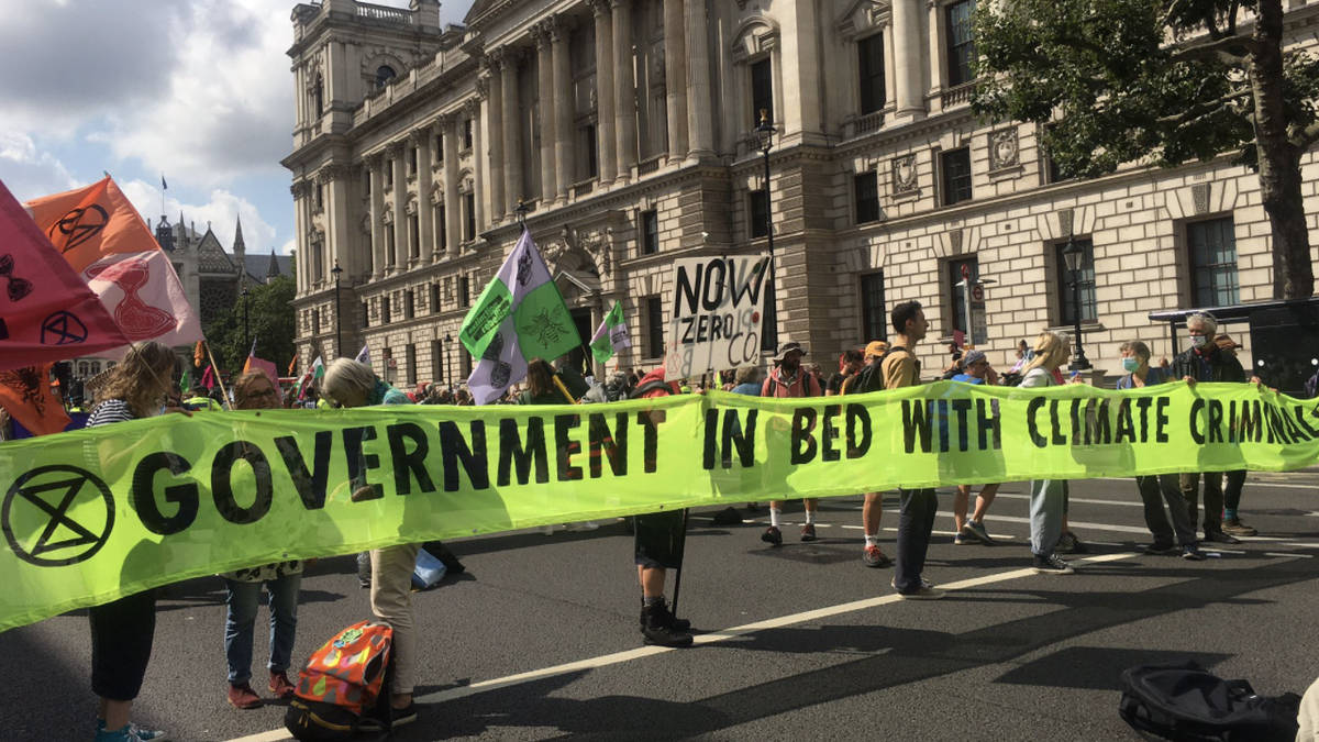 Extinction Rebellion protesters block Whitehall as giant pink table is ...