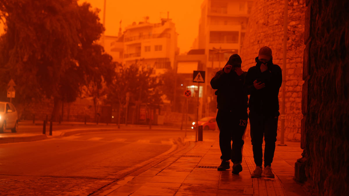 Storm turns sky red in Greece as man dies and flights disrupted after heavy rain and winds