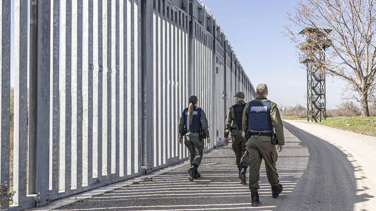 Masked migrants 'recruited by Greek police' to force other migrants back across border into Turkey