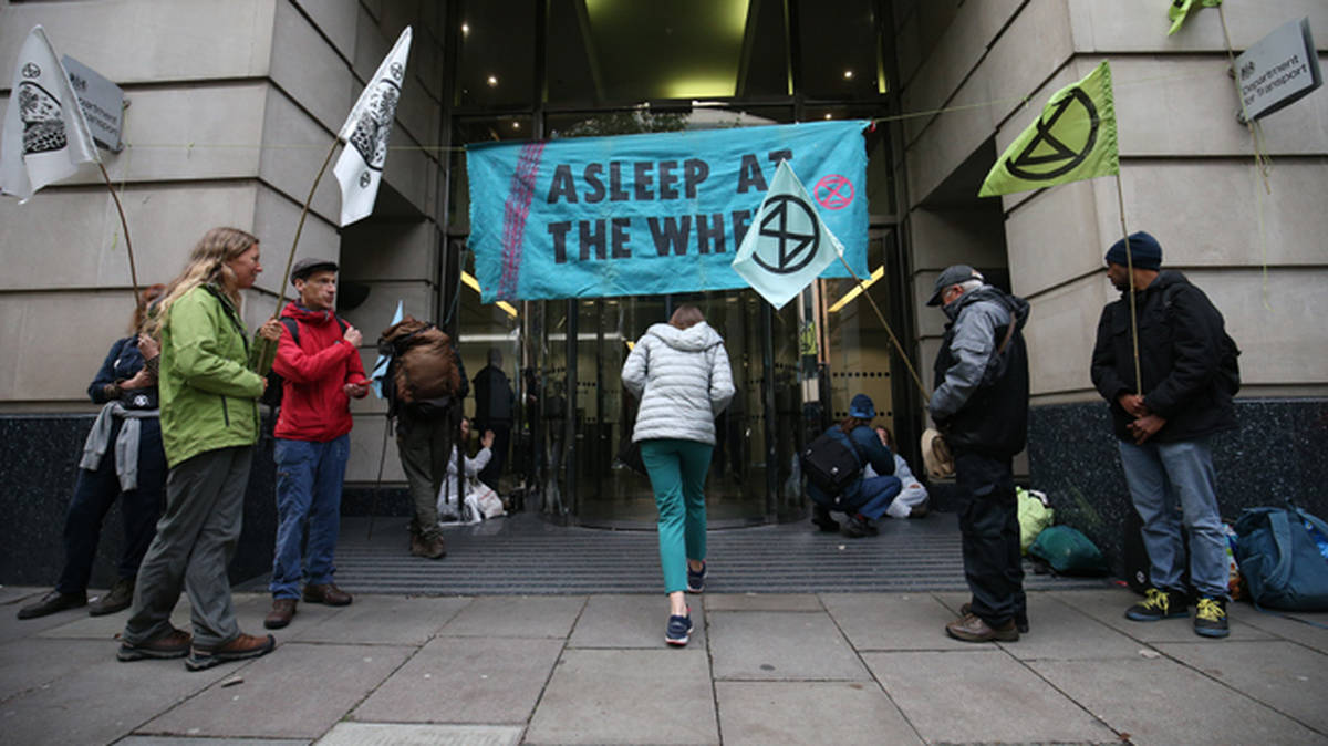 Extinction Rebellion protesters glue themselves to Government buildings ...