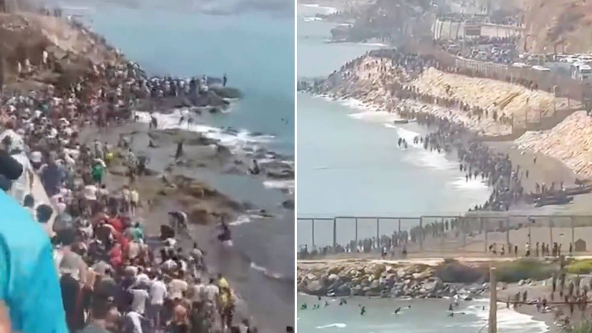 Thousands of migrants climb barbed wire fences and force their way into Spanish territory as they storm EU border